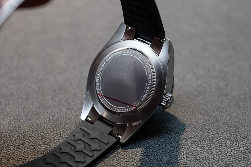 Caseback of Tudor Black Bay GMT with engraving, mounted on black rubber strap