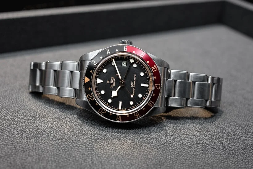 Front view of Tudor Black Bay GMT with red and blue bezel, displayed on a flat surface